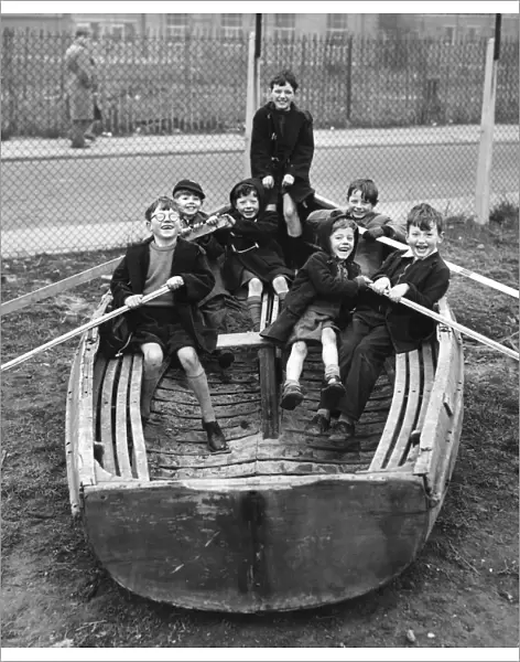 Children playing in an old boat in the Triangle Adventure Playground converted