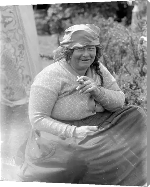 A Romany gypsy woman smoking her pipe at the Epsom Races. Late 1940s, early 1950s