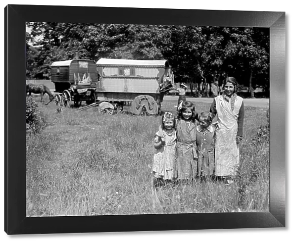 Romany gypsy girls posing outside their caravans on Epsom Downs during the Epsom