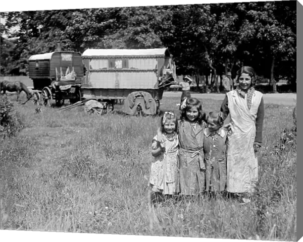 Romany gypsy girls posing outside their caravans on Epsom Downs during the Epsom
