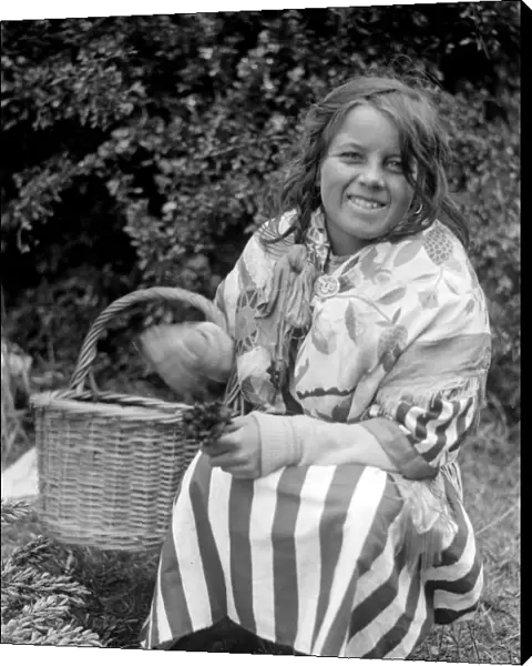 Gypsy girl with her basket of lucky heather. Late 1940s, early 1950s