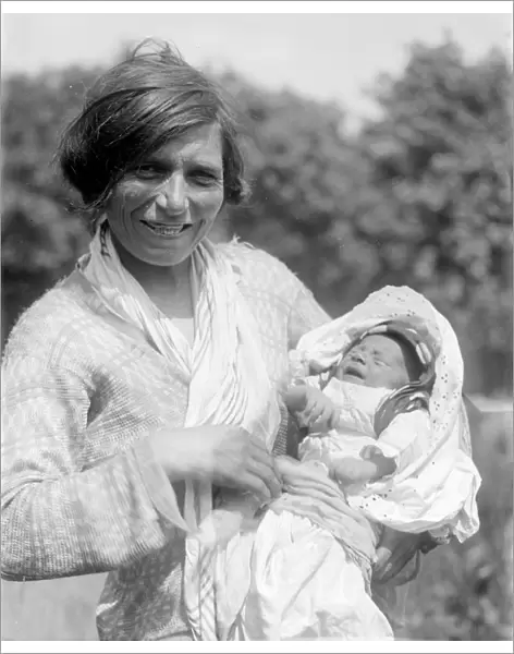 A Romany gypsy mother holds her baby at the Epsom Races. Late 1940s, early 1950s