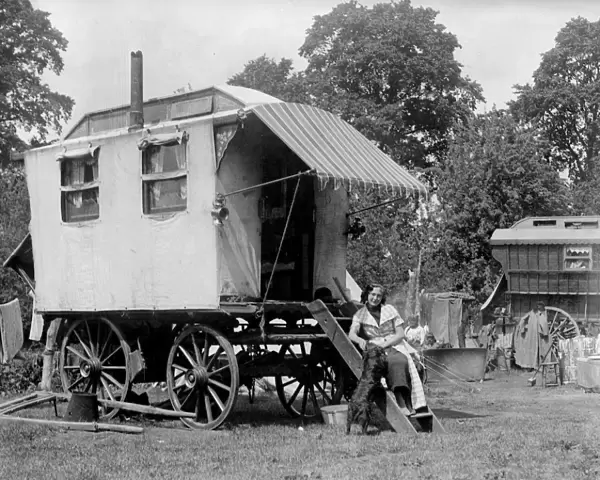A gypsy woman sitting on the steps to her Romany caravan in the gypsy camp on Epsom Downs