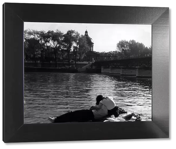 Romantic couple on the banks of the Seine, Paris in 1950s love couple romance romantic