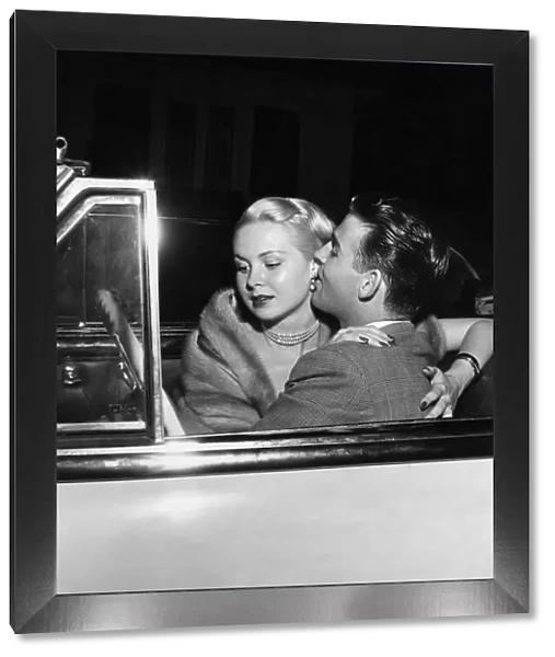 Glamorous American actress, Joi Lansing in a romantic embrace with her boyfriend