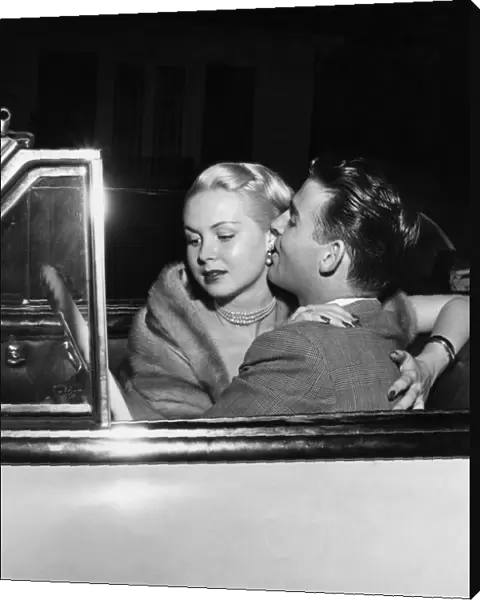 Glamorous American actress, Joi Lansing in a romantic embrace with her boyfriend