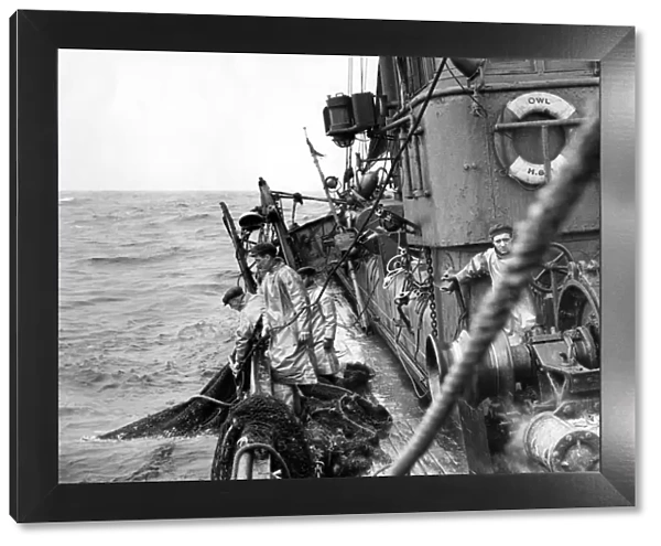 Fishermen on board a trawler in the North Sea hauling in their nets Fish where the fish are