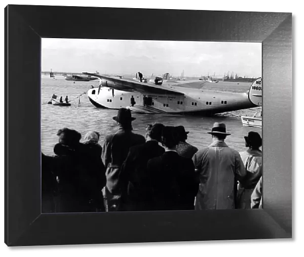 Crowds meet the giant new American flying boat Yankee Clipper as she moors at