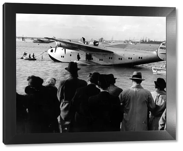 Crowds meet the giant new American flying boat Yankee Clipper as she moors at