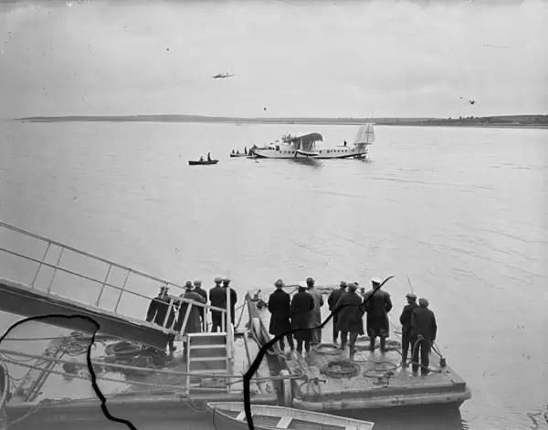 Cheering crowds. The Clipper landing on sea