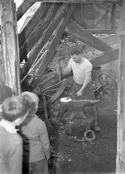 9 November 1940 Doug Hollands blacksmith forge, over 100 years old. Despite being