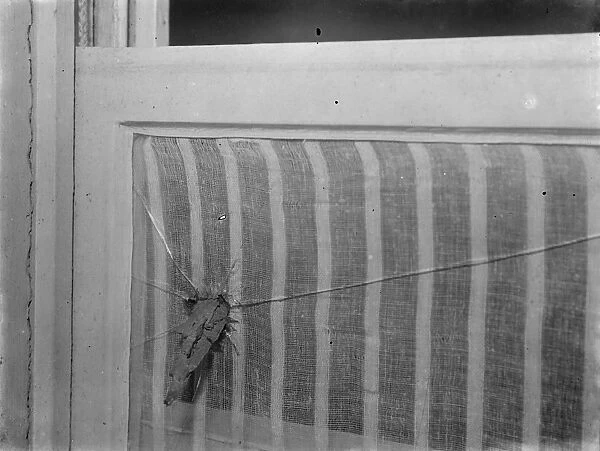 9 November 1940 Shrapnel in the window caused by during bomb damage in a Nazi bombing