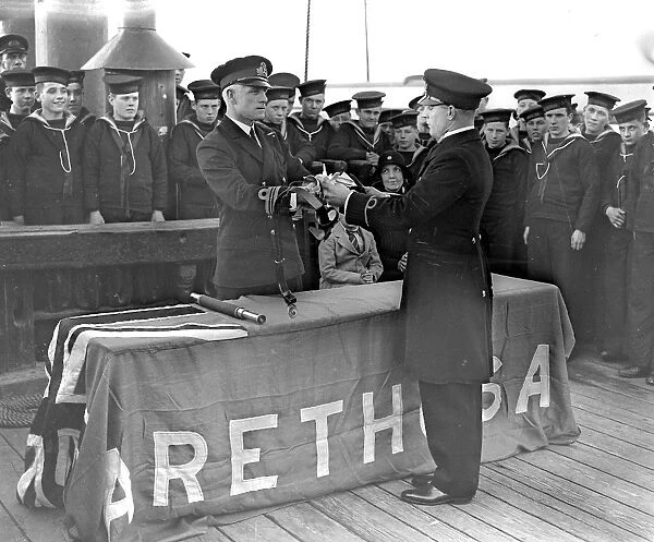 Aboard Arethusa training ship. Commander C. W. Bower (commanding Arethusa) presenting