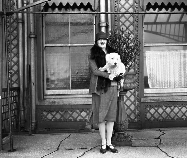 The actress, Miss Phyllis Titmuss pictured with her pet dog in Brighton, Sussex
