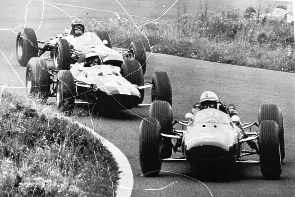 Adenau Germany John Surtees driving a Ferrari leads the pack in the second lap of