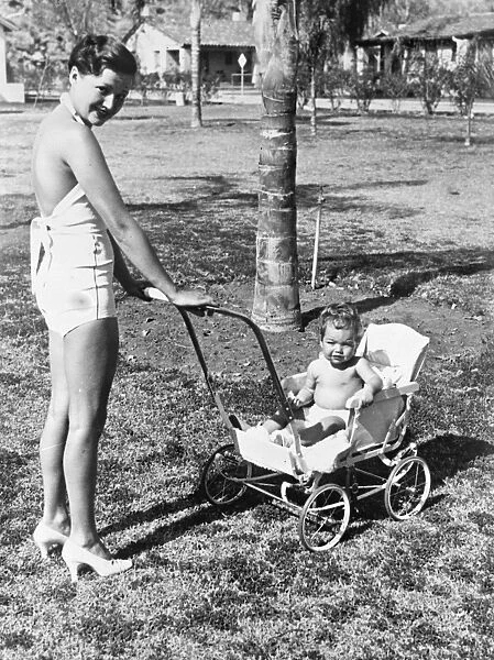 Arlene Judge takes baby for a ride in the Californian sunshine. Mrs Wesley Ruggles