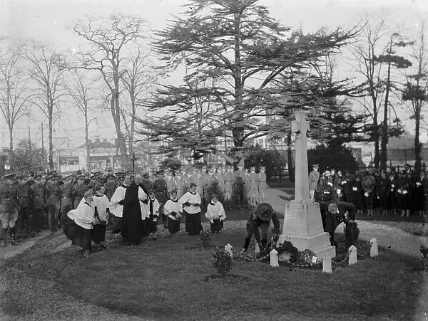 Armistice memorial service in Erith, London. The priest and choirboys leads the