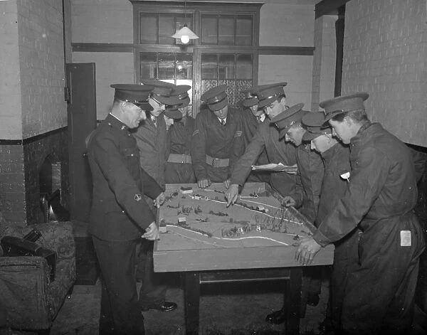 Army officers using a model of terrain for instruction on tactics at the Dartford