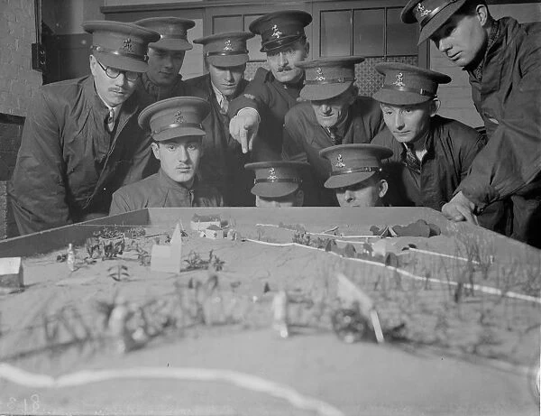 Army officers using a model of terrain for instruction on tactics at the Dartford
