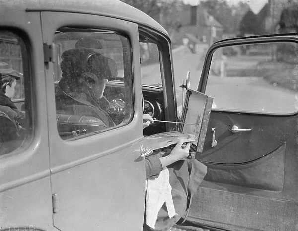 Artist painting at the wheel of his car in Eynsford, Kent. 1938