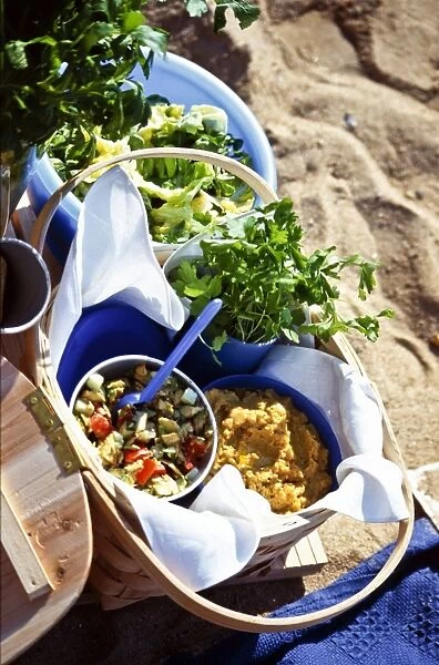 Beach picnic with salads in bowls and baskets credit: Marie-Louise Avery  /  thePictureKitchen