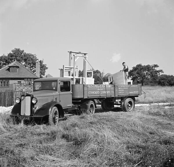 A bedford truck from Austin and Eastham Standar Joinery, arrives at a job with
