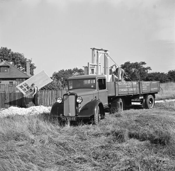 A bedford truck from Austin and Eastham standar joinery, unloads a trailer full
