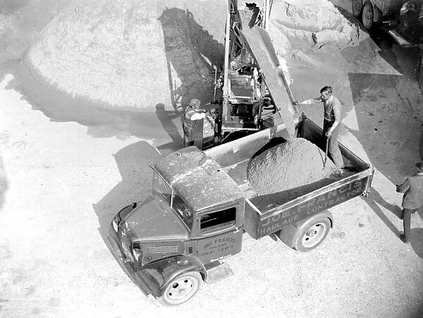 Bedford truck being loaded by a conveyor loader at the Sand & Gravel Co Ltd gray