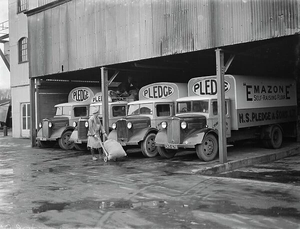 Bedford trucks belonging to Pledge & Son Ltd, the milling company, being loaded