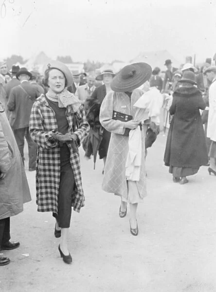 The biggest at Ascot. An outsized hat worn by a women racegoer as she left Waterloo for Ascot