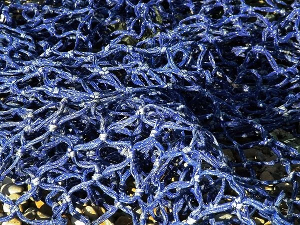 Detail of blue fishing net in the sunshine credit: Marie-Louise Avery  /  thePictureKitchen