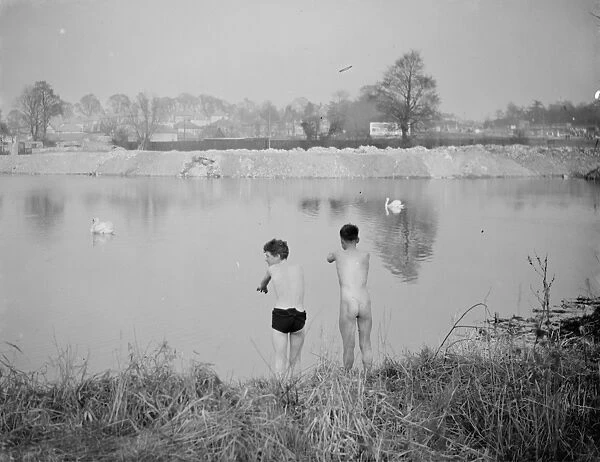 Two boys bathing in the lake at Foots Cray meadows during the winter