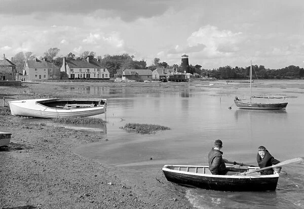 Boys in boat with The Royal Oak at Langstone Harbour in jthe background, Langstone
