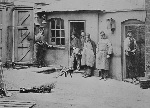 Brewery workers take a break from work for a portrait at the Thames Bank Distillery
