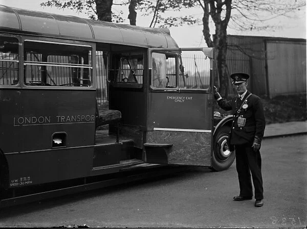 A bus conductor showing the large access door on a diesel bus, Longfield