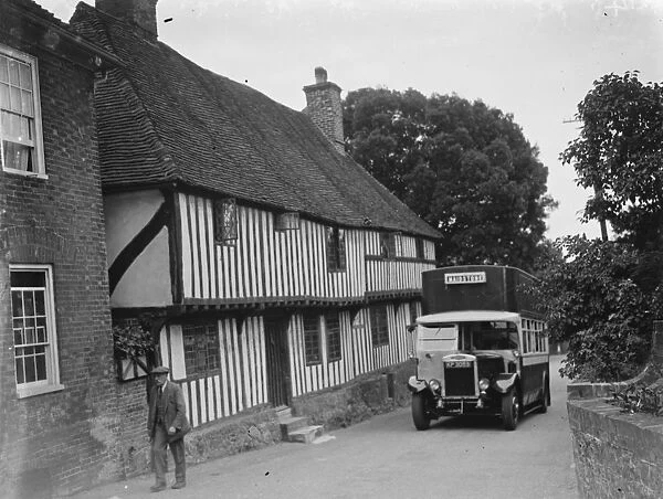 A bus passing a pretty cottage in Hollingbourne, Kent. 1935