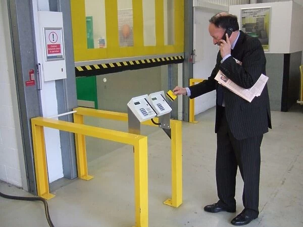 Business man entering a building using a swipe card. ?TopFoto