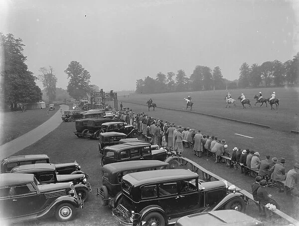 Cars parked by the grandstand at the horse polo game