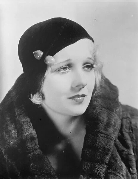 A charming hat thats popular this season. The brimless hat, Miss Anita Page