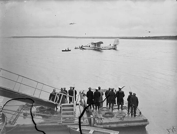 Cheering crowds. The Clipper landing on sea