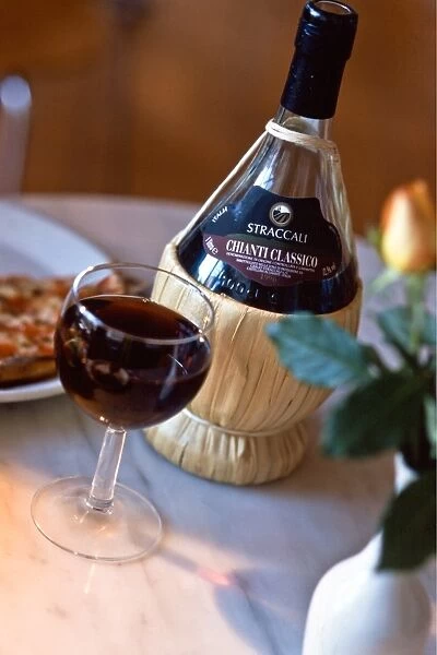 Chianti classico in traditional old fashioned raffia covered bbottle on restaurant
