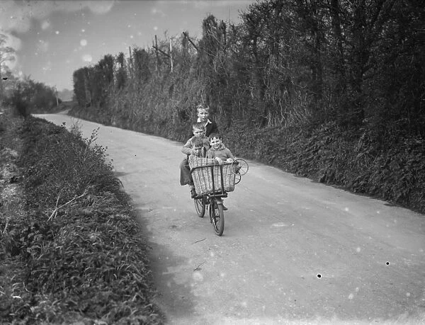 Four children on a bike in the country. 1936