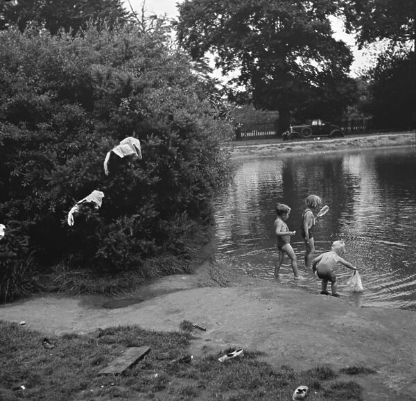 Children enjoy a paddling pool in Chislehurst, Kent. 1938