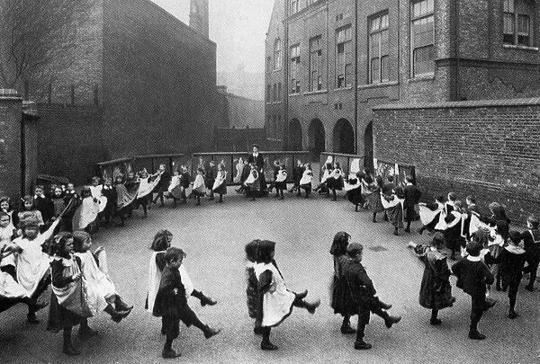 Children in a London council school learn the first steps in dancing. 1908