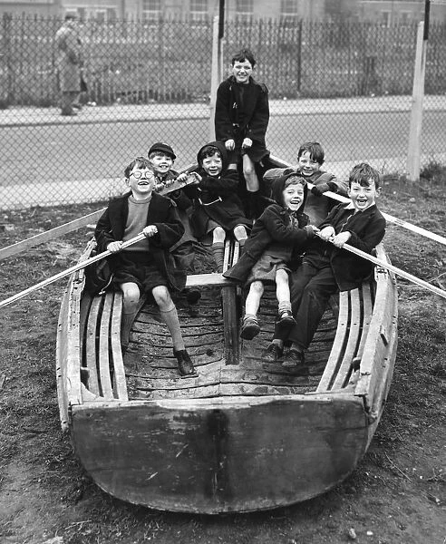 Children playing in an old boat in the Triangle Adventure Playground converted