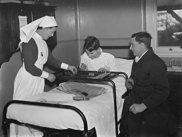Christmas at the County Hospital in Dartford, Kent. Patients play dominoes
