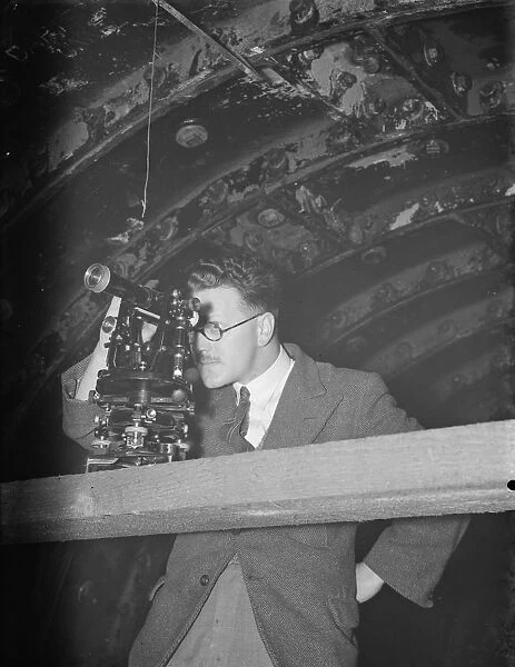 The construction of the Dartford Tunnel. An engineer takes readings with his theodolite