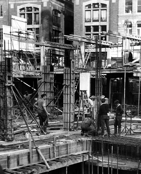 Construction workers working on a building site in central London, England