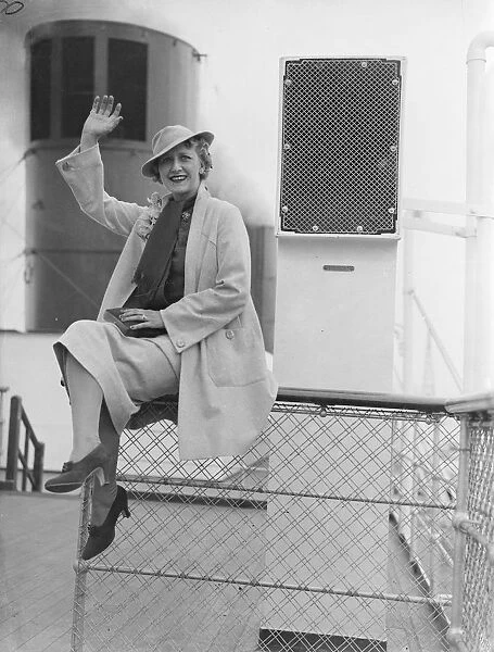 Cora Goffin, the well - known British comedy actress, waves to the camera onboard ship