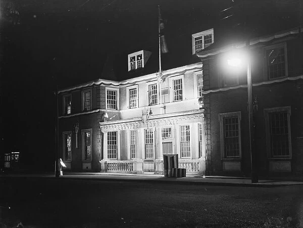 Coronation decorations at the floodlit Crayford Town Hall, Kent, to celebrate the